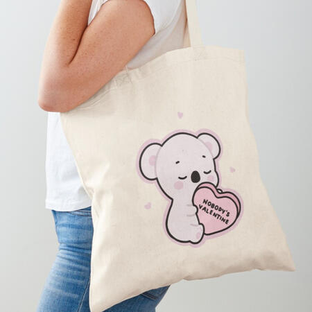 minimal cute soft koala holding a Valentine's Day heart candy. the perfect tote bag to complete your look for a casual laid back date.